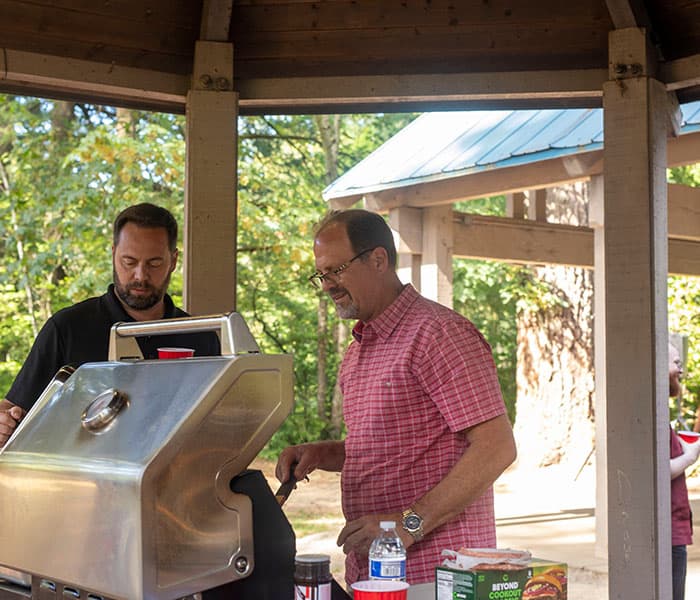 Company leadership cooking food for their employees